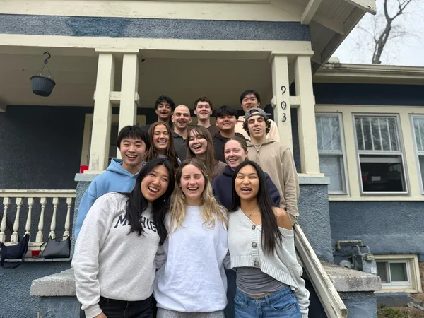 TEK members gathered on the front steps of a house